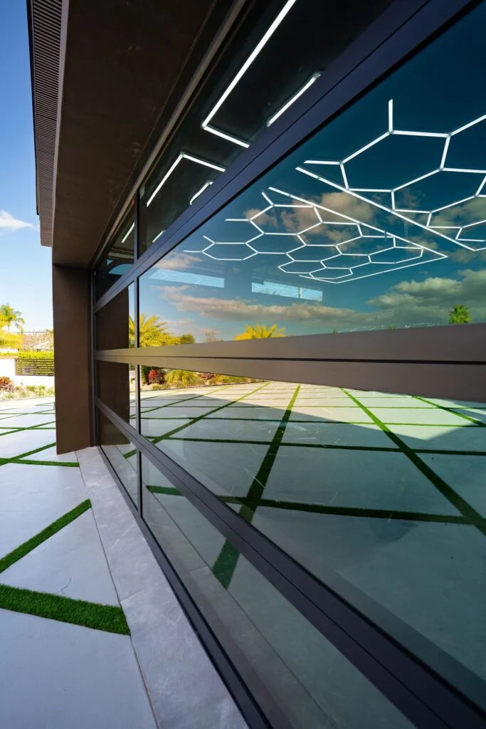 Close view of a Dubai Framed glass section reflecting the garage's hexagon lights