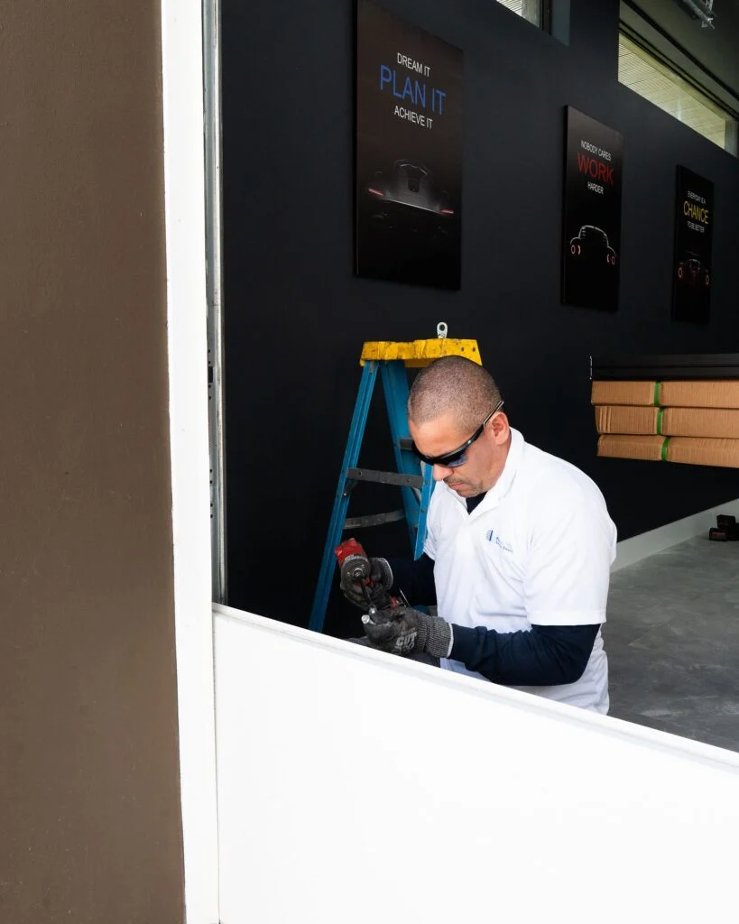 Installer finishing a Dubai Framed door from inside the garage