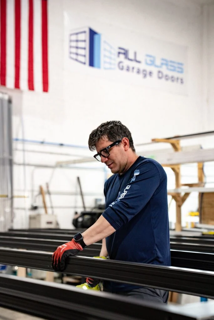 All Glass technician working under an American flag in the Doral factory